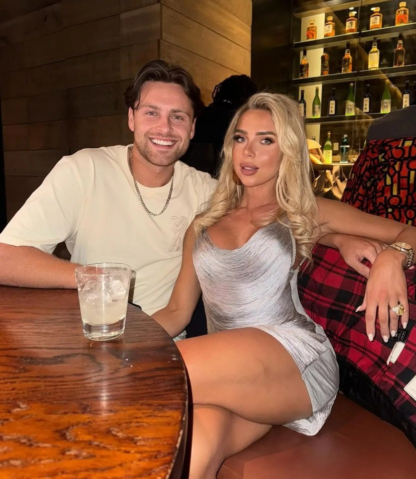Photo of a couple sitting at a table in a bar.