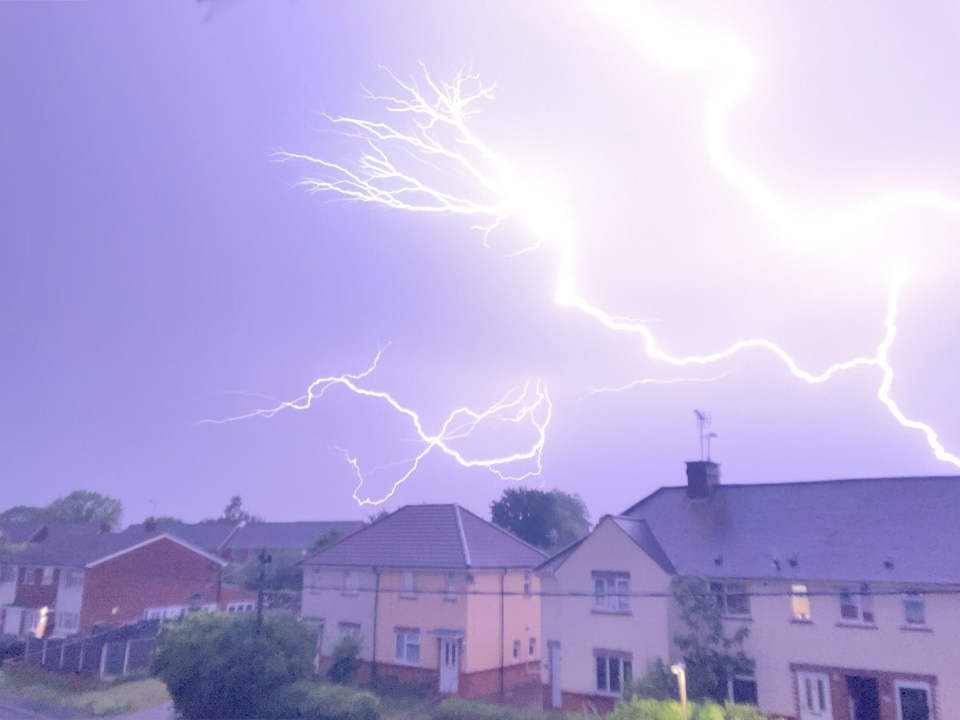 Lightning strike over houses.