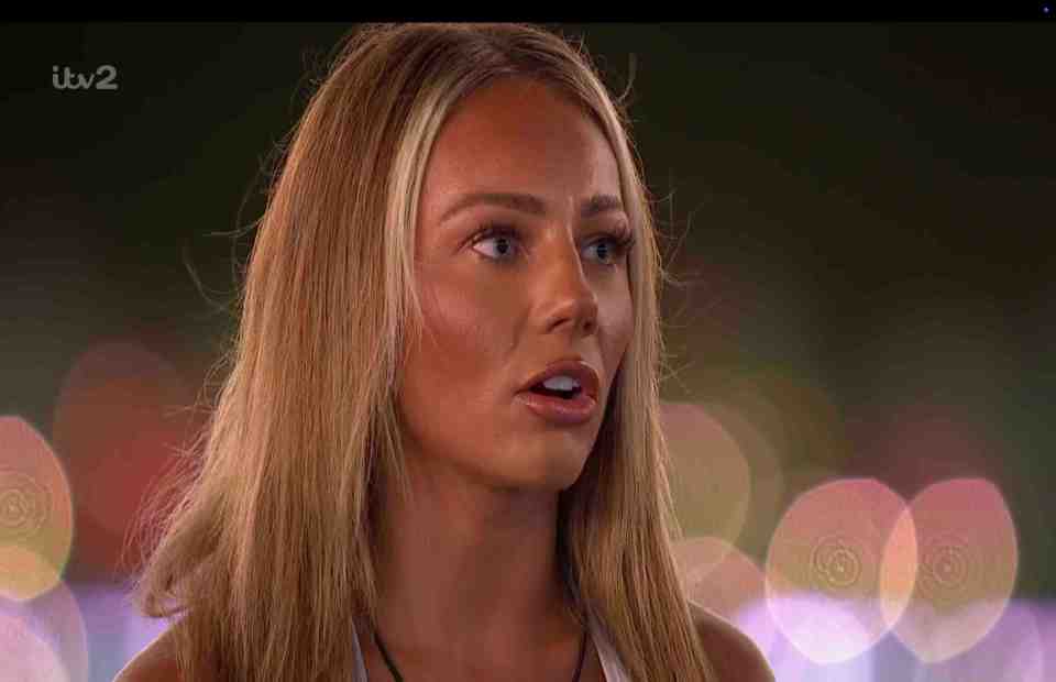 Meg from Love Island watching the boys on a giant screen.