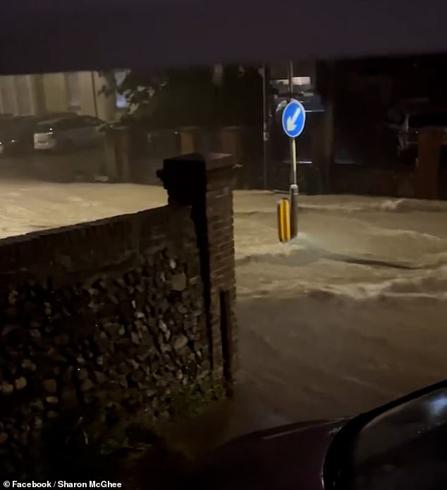 Video footage shows floodwater moving down a residential road in Dover on Friday night