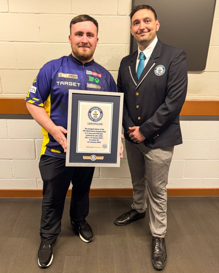 Two men holding a Guinness World Records certificate.