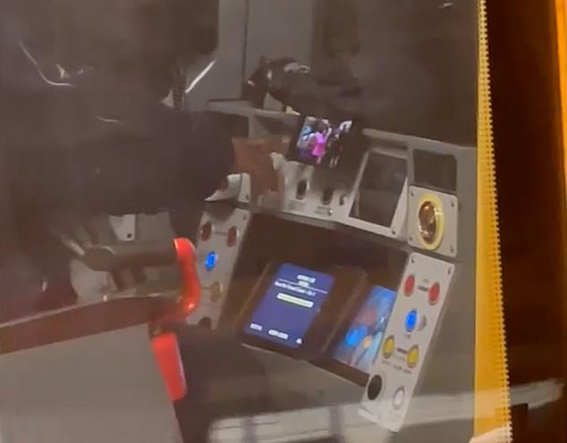 The man's phone is also positioned comfortably in front of him so he can watch videos at his leisure