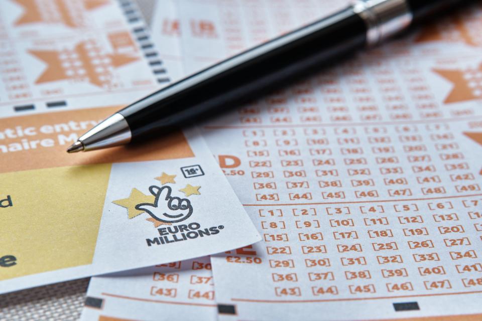 EuroMillions lottery tickets and a pen.