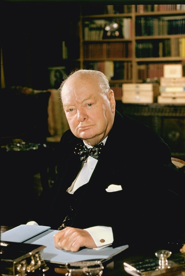 Formal portrait of Winston Churchill at his desk.