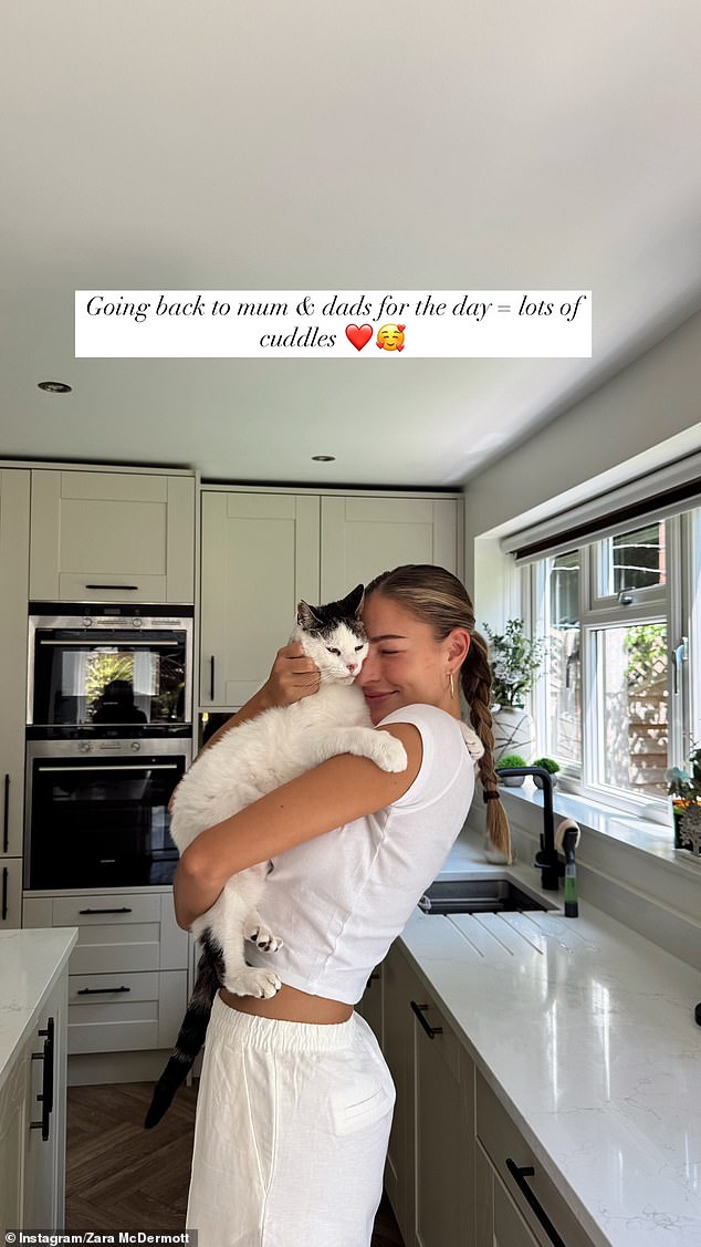 Zara took to Instagram to share an adorable snap of her holding a white cat on Friday, while rocking a casual white t-shirt and matching trousers