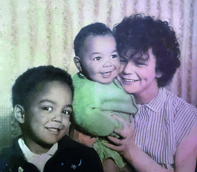 Mr Downes had a tough childhood, sometimes going hungry. Pictured with his mother and brother
