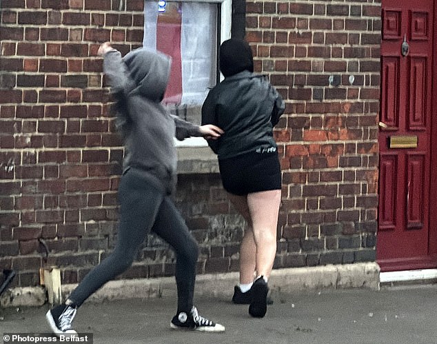 Police fired water cannon at petrol bomber and youths - including these girls - who were pelting their lines with rocks and bottles