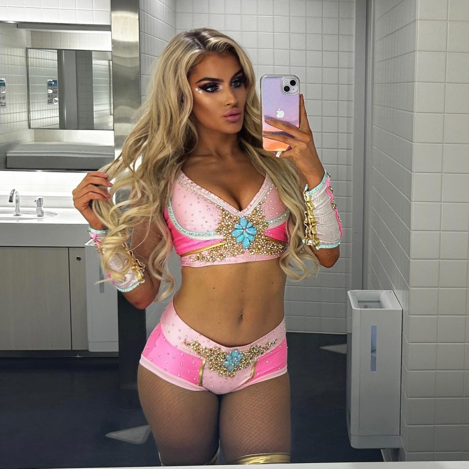 Selfie of Mariah May, AEW wrestler, in a pink wrestling outfit.