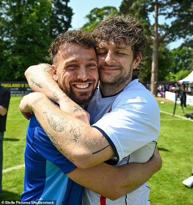 Sam looked in good spirits as he hugged pop singer Tom Grennan