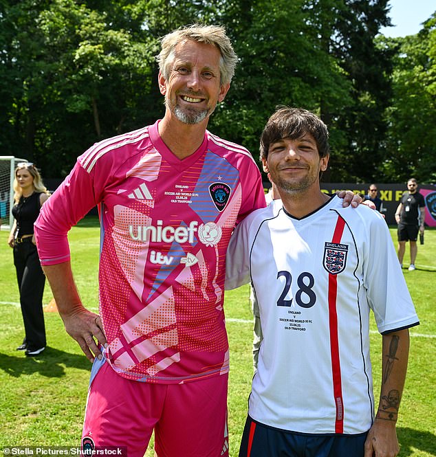 Louis did sport a smile as he posed for a photo with Dutch former footballer Edwin van der Sar