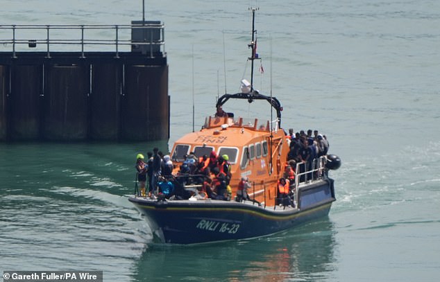 A group of people thought to be migrants are brought in to Dover, Kent, onboard the RNLI Ramsgate Lifeboat on Friday
