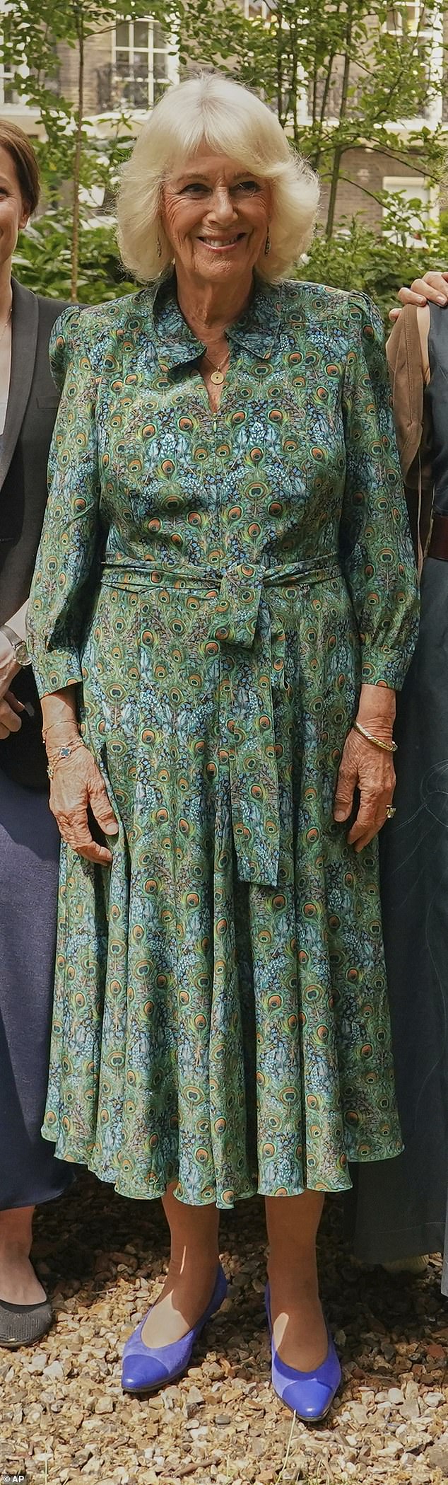 Camilla looked regal as she stepped out in the eye-catching Grace dress made with Liberty Green Peacock Manor Silk from Bombshell London