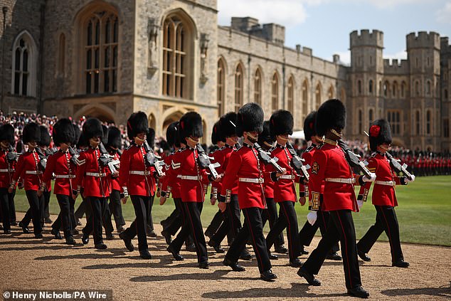The honour to Troop their Colour rotates between five regiments of the Foot Guards. This year it is the turn of Number 7 Company of the Coldstream Guards. Above: Members of the Coldstream Guards marching yesterday at Windsor Castle, where the King presented four new Colours to the 1st and 2nd Battalion to mark their 375th year