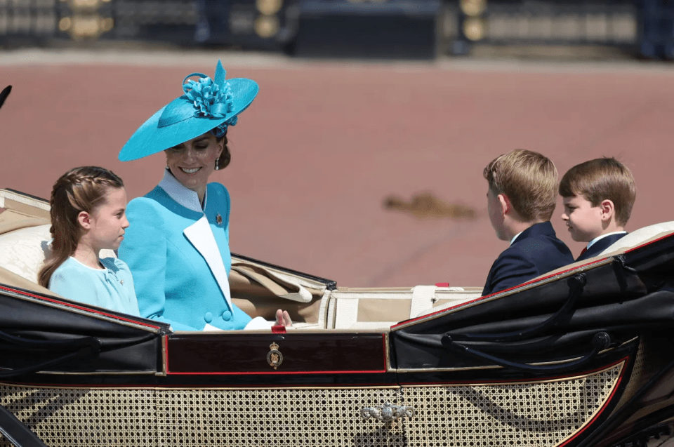 Kate Middleton, Princess Charlotte, Prince George, and Prince Louis in a carriage.