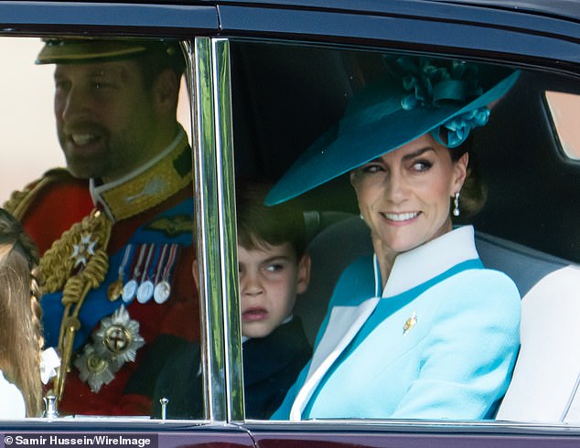 The Prince and Princess of Wales with their youngest child, Prince Louis, seated between the royal couple