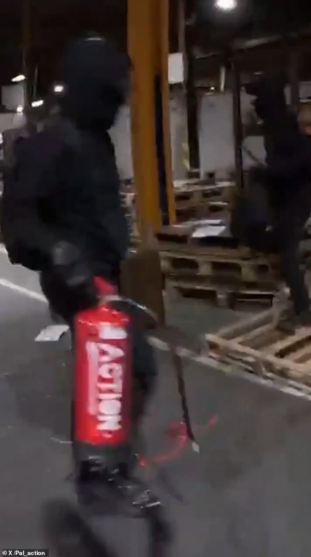 As the footage ends, a Palestine Action member can be seen walking with a red canister