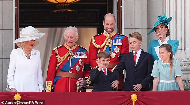 Prince George appears to try and temper his younger brother Louis, who is enjoying greeting the crowd