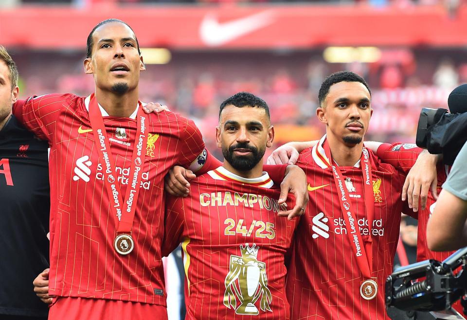 Liverpool players Virgil van Dijk, Mohamed Salah, and Trent Alexander-Arnold with Premier League winner's medals.