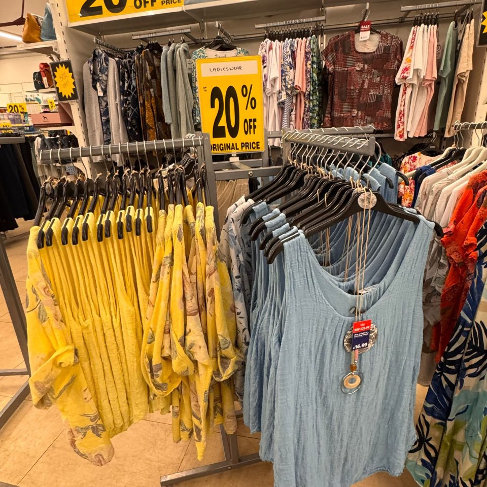 Women's clothing on display in a store, with a 20% off sale.