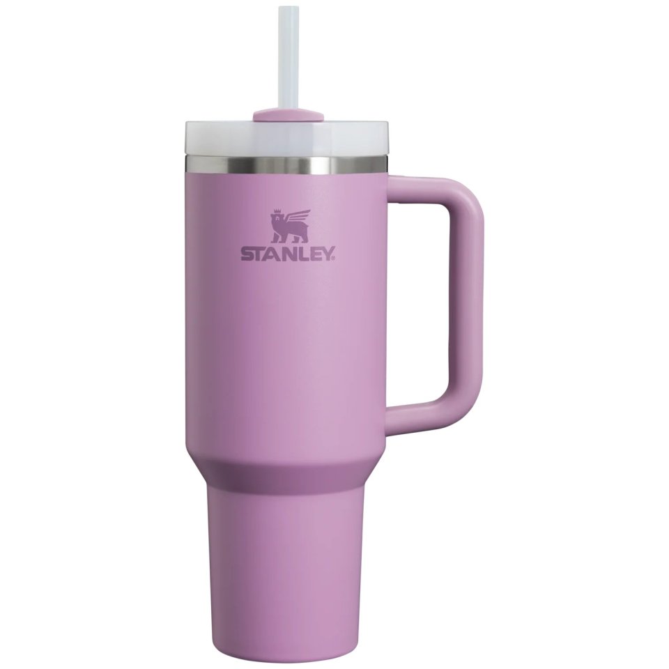 a purple stanley mug with a straw in it