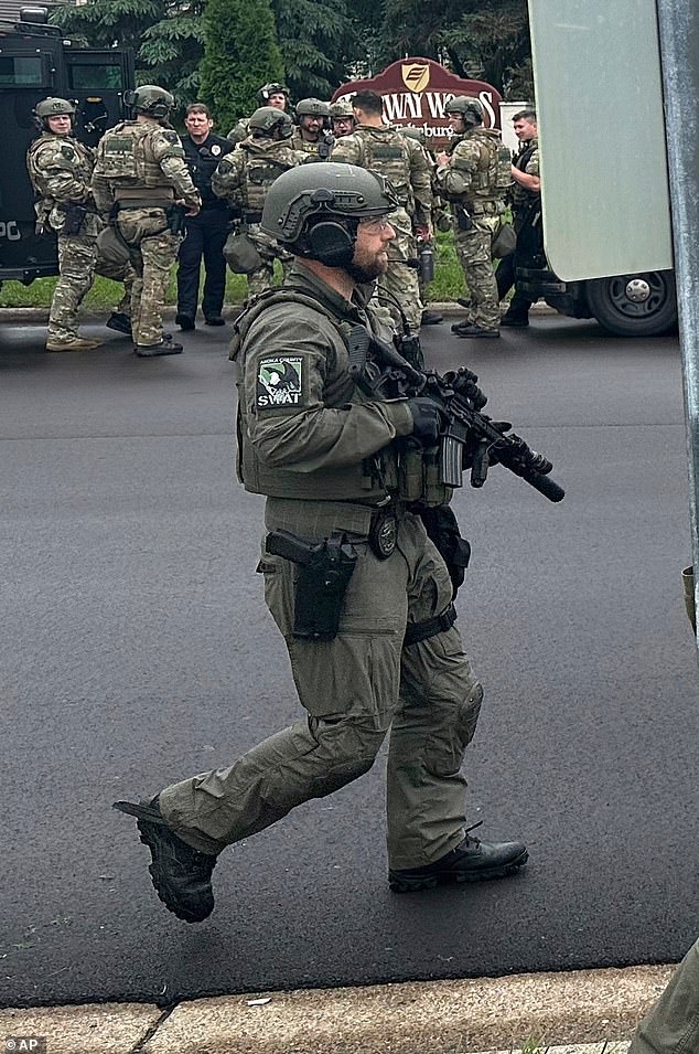 Authorities believe the two incidents are connected and involve a suspect posing as law enforcement. A SWAT agent is pictured in the search for the suspect on Saturday