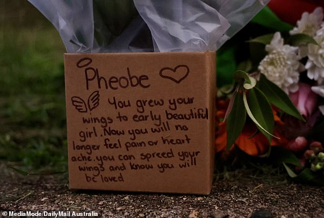 A makeshift memorial has appeared at the ramshackle, rubbish-strewn Gin Gin home she shared with Wood and Bromley