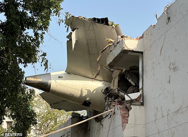 The tail of the Dreamliner plane that crashed, hitting buildings in a residential area