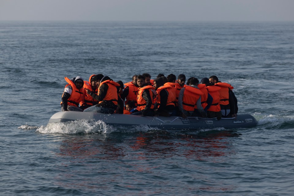 Migrants in an inflatable boat crossing the English Channel.