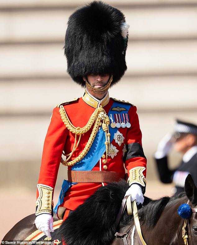 An unrecognisable Prince William rides a horse during Trooping the Colour