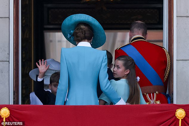 Prince Louis and Princess Charlotte turn back towards the crowds as they leave the balcony at Buckingham Palace