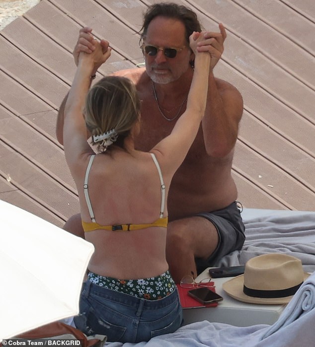 Years into their relationship, Helen and Jeffrey still looked in the first flush of romance, holding hands and gazing into each other's eyes as they sat together