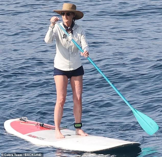 For that activity, she pulled a stylish, fluttery white blouse and a set of Daisy Dukes on over her swimsuit, accessorizing with a straw hat