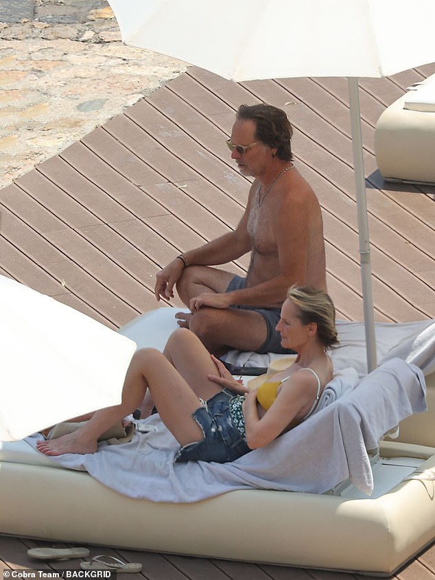The couple could be seen lounging on deck chairs side by side