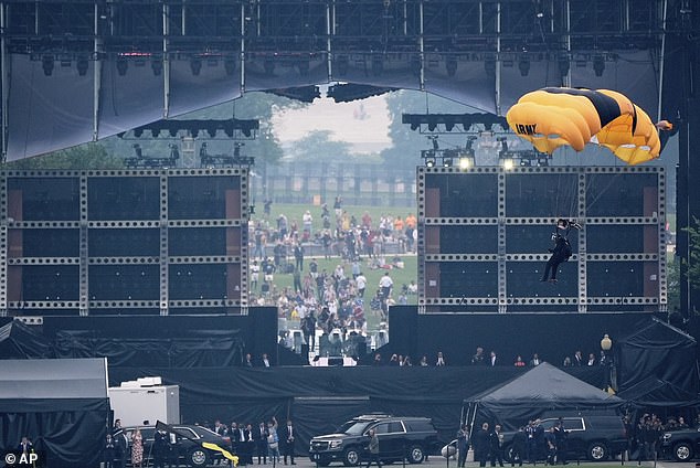 A member of the U.S. Army Parachute Team Golden Knights makes their landing behind the viewing stand on the Ellipse during the Army's 250th birthday parade. Other flyovers took place over the Washington Monument