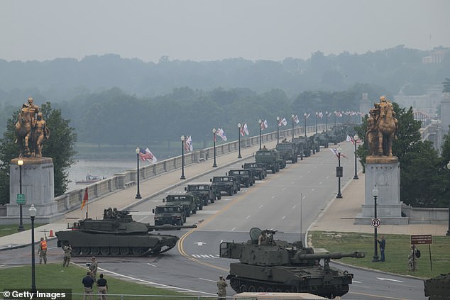 Members of the U.S. Army drive a Paladin self propelled howitzer, M1 Abrams battle tank and Joint Tactical Vehicles into Washington, D.C. Saturday to participate in the military parade