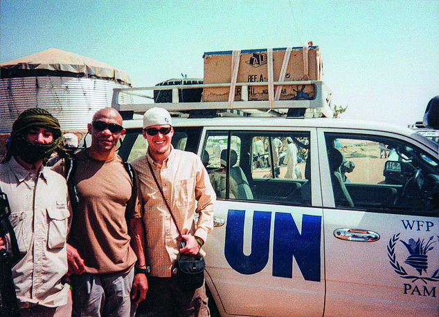 Pictured: Mr Downes With CBS News and the UN in Darfur in 2005 - He said working alongside journalists gave him a totally new perspective on the world