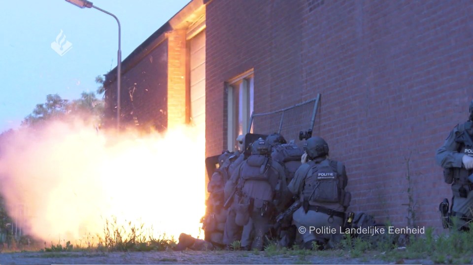 Police tactical unit breaching a building.