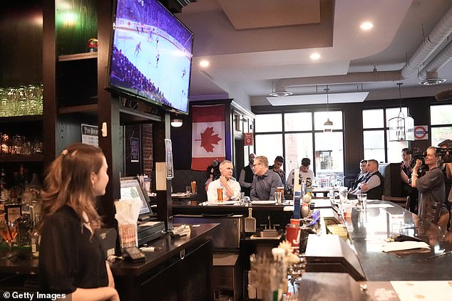 The leaders chatted as they watched a televised ice hockey game between Edmonton Oilers v Florida Panthers at the Royal Oak pub