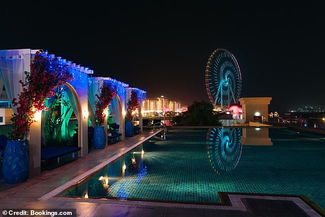 The view from the restaurant at night takes in the infinity pool and the skyline of the JBR