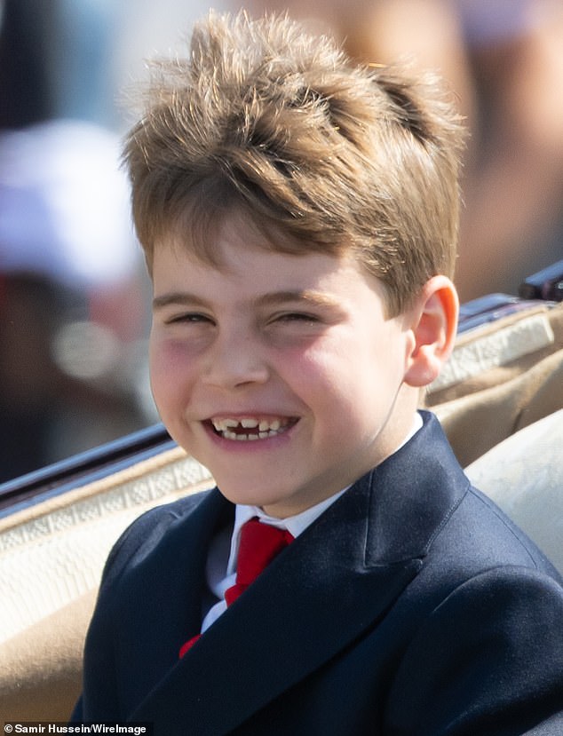 A gust of wind catches Prince Louis off guard, as he beams out the crowds with windswept hair
