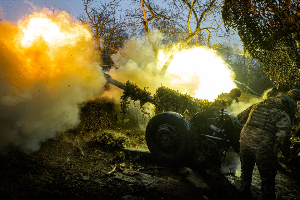 Ukrainian soldiers operating a howitzer.