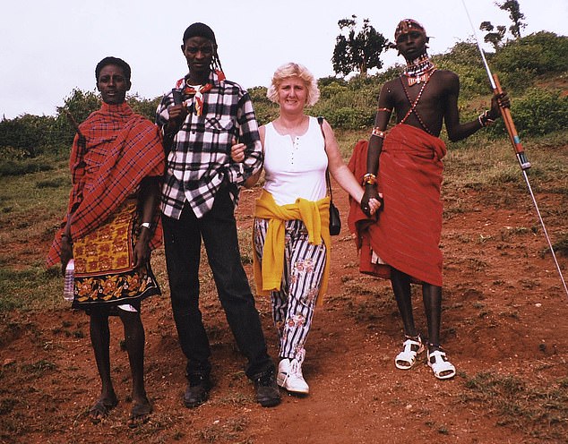 Cheryl in Kenya with Daniel and his two brothers Lmakayo and Taloni