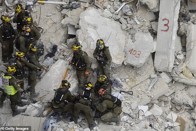 Emergency and rescue soldiers extract a dead body out from rubble around heavily damaged buildings after an overnight missile strike from Iran on June 15, 2025 in Bat Yam Israel