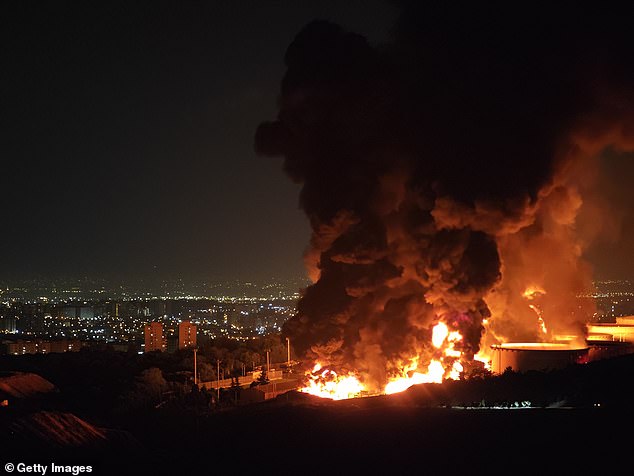 Fire and smoke rise into the sky after an Israeli attack on the Shahran oil depot on June 15, 2025 in Tehran, Iran