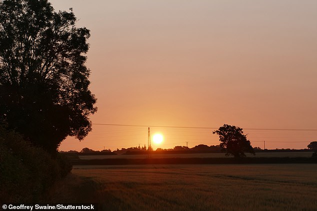 The sun rises over the countryside in Dunsden, Oxfordshire. Britain is set for another warm day on Sunday with temperatures to reach 24C