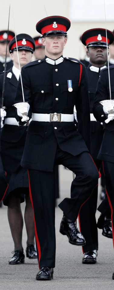 Prince Harry in military uniform marching with a sword.
