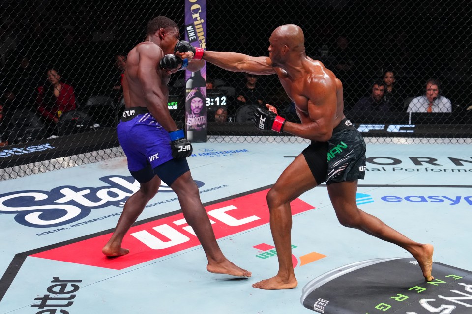 Kamaru Usman punching Joaquin Buckley in a UFC welterweight bout.
