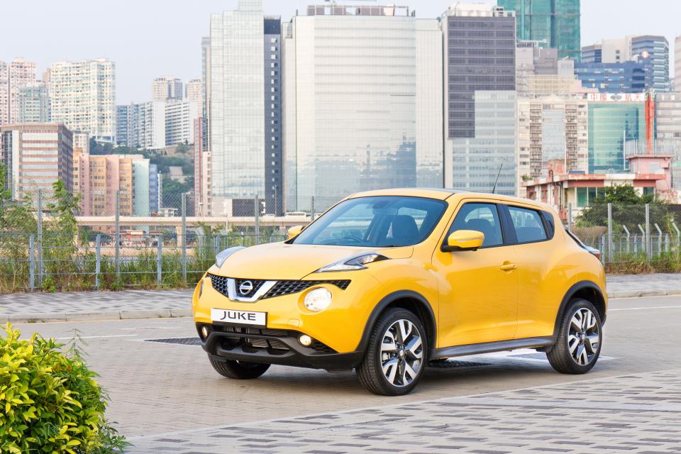 Yellow Nissan Juke parked in a city.