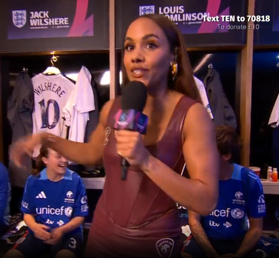 Reporter interviewing soccer players in a locker room.