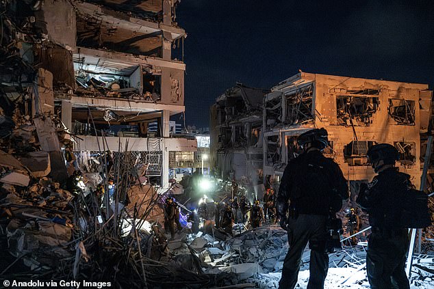 Israeli civil defense and fire brigades continue search and rescue operations after Iranian strikes damage buildings in Bat Yam, Israel